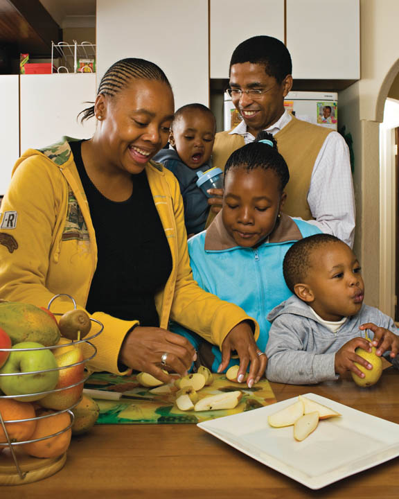 A photo of an African-American family preparing dinner together.