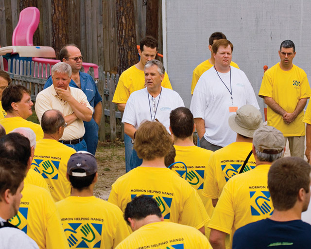 A photo of Mormon Helping Hands volunteers gathered to listen to instructions for a project.