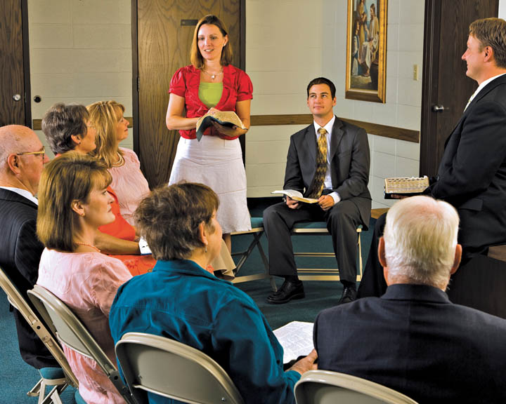 A photo of a young woman speaking in a Sunday School class.