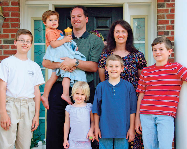 A photo of a Mormon family, consisting of a father, mother, and five children.