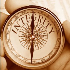 Someone holding a compass with the word "integrity" on the dial.