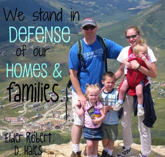 "We stand in defense of our homes & families." - Elder Robert D. Hales; A photo of a family on a mountain.