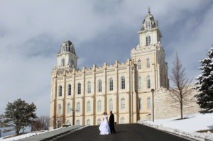 A photo of a couple standing in front of a temple after being married and sealed there.