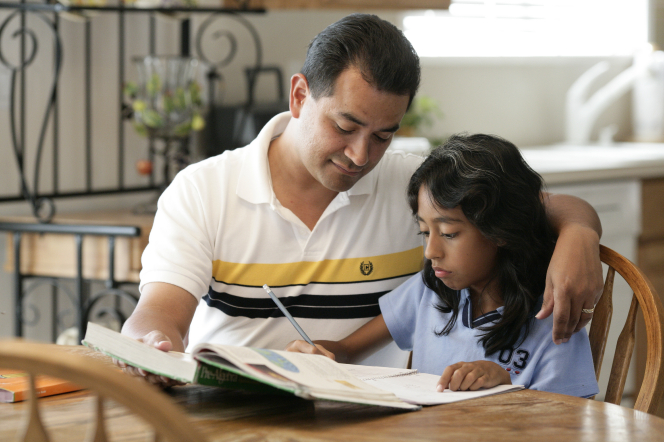 Father helping daughter with homework