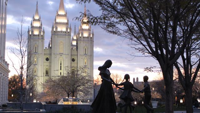 Statue of a family in front of the Salt Lake LDS Temple.