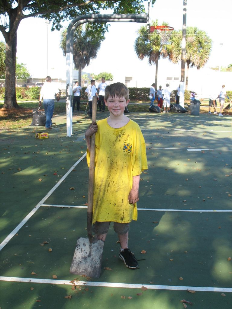 A boy is dirty after helping out during the Miramar Day of Service.