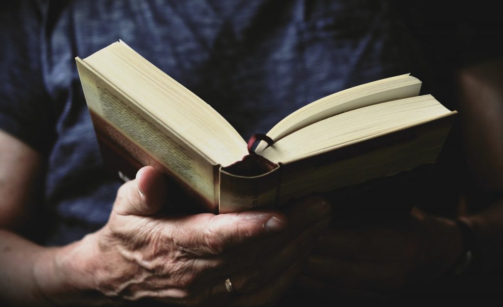 A woman reads a book. My grandma taught me a love of learning, and my new year's resolution is to set this example for my children.