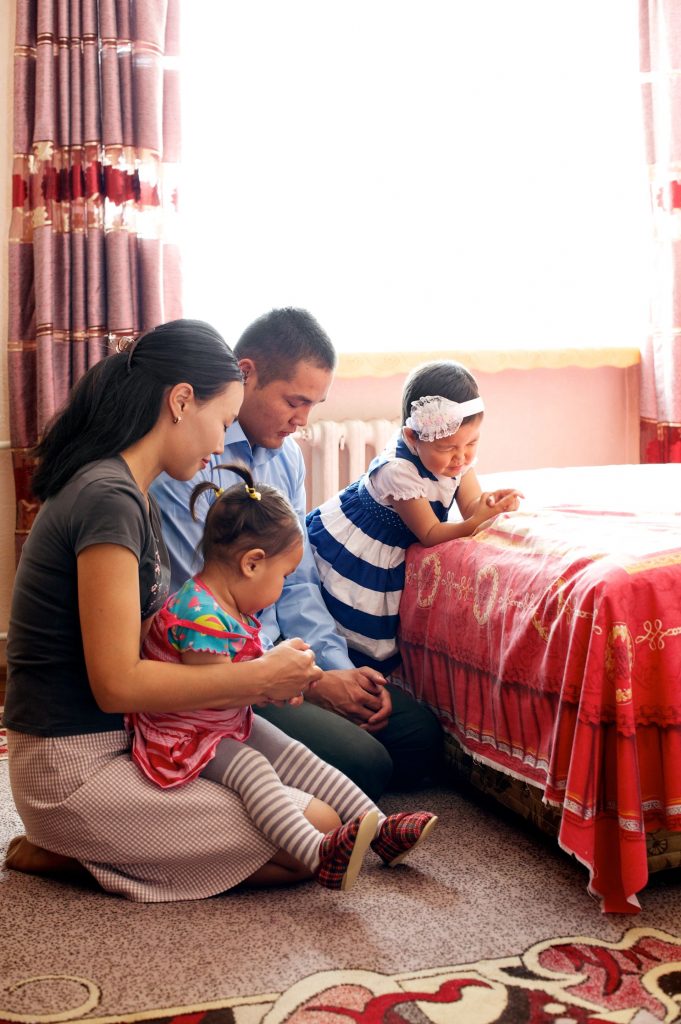 A family praying together at home.